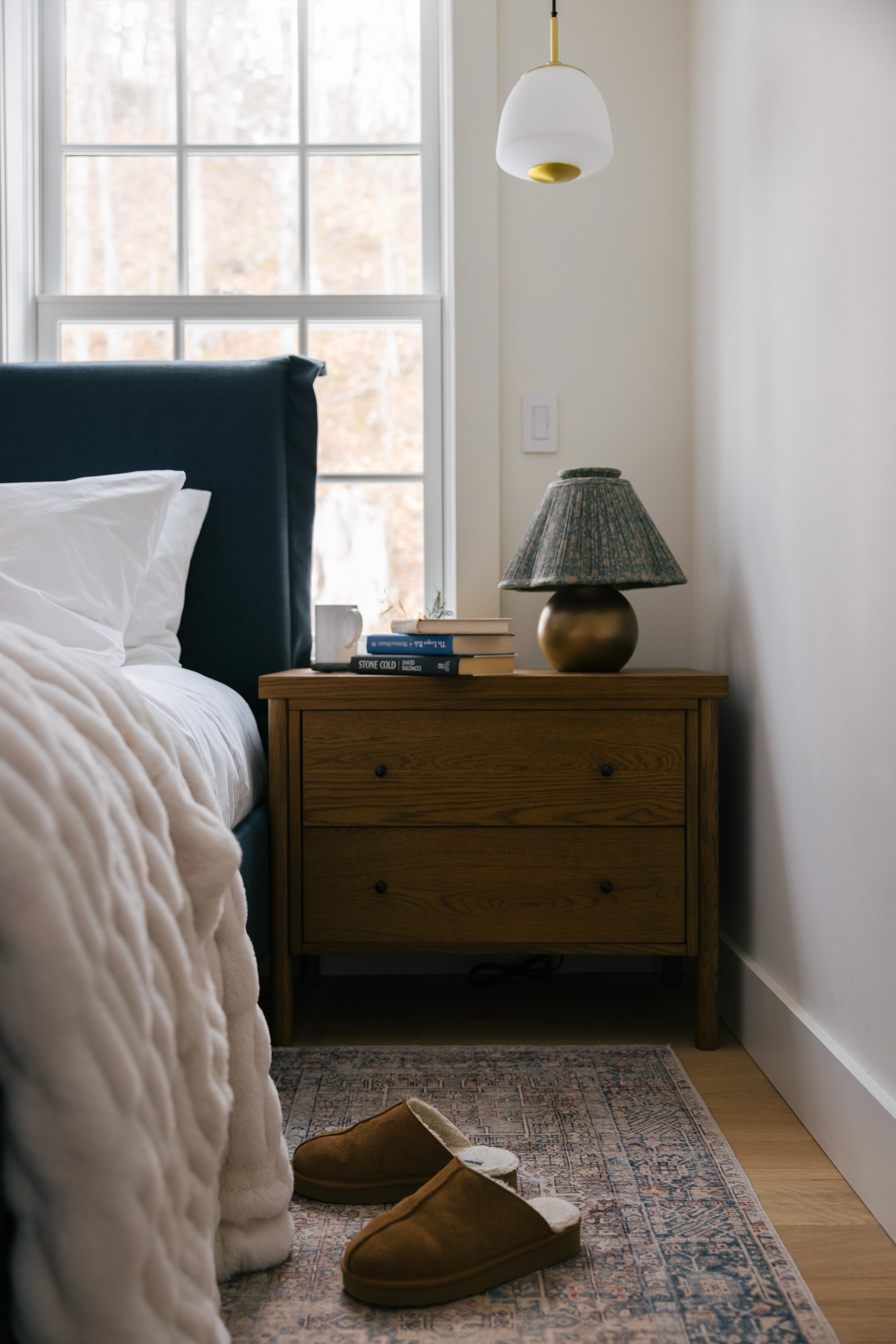 Downstairs king bedroom second view with fresh styling and cozy layered bedding